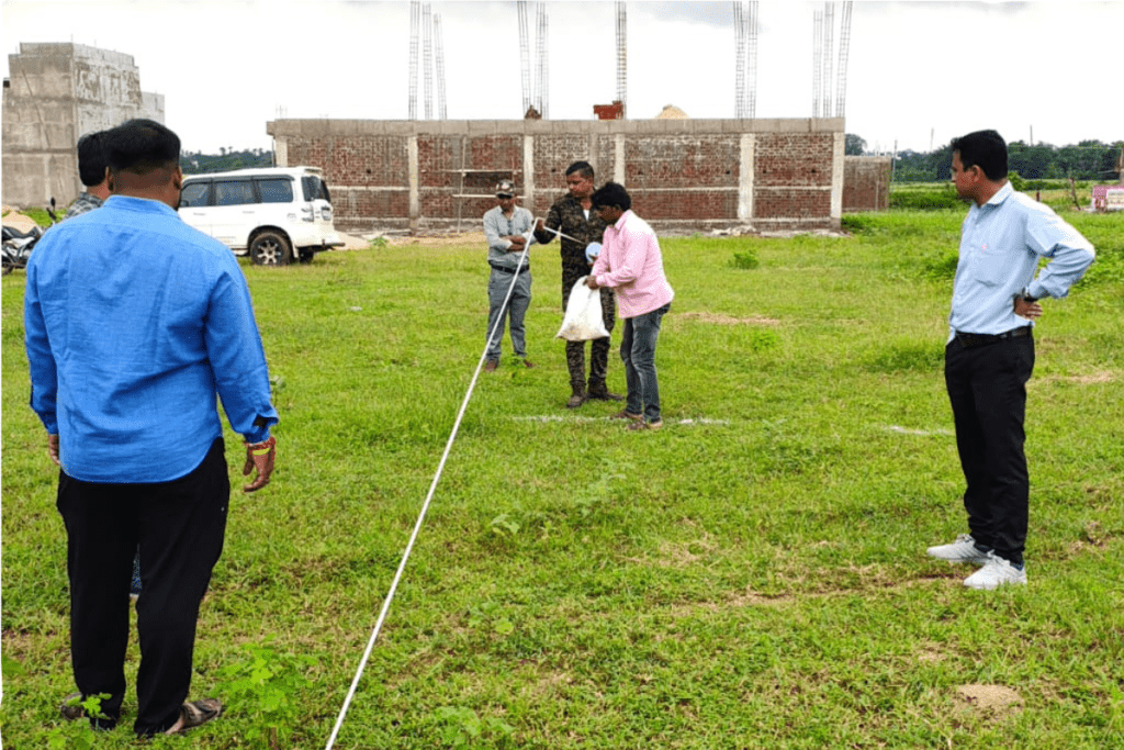 Licensed land surveyors verifying site boundaries and land measurements with professional surveying equipment