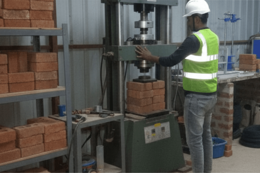 Laboratory technicians evaluating bricks to determine strength, construction material permeability, and endurance.