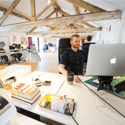 A digital marketing specialist working at a contemporary office workstation.